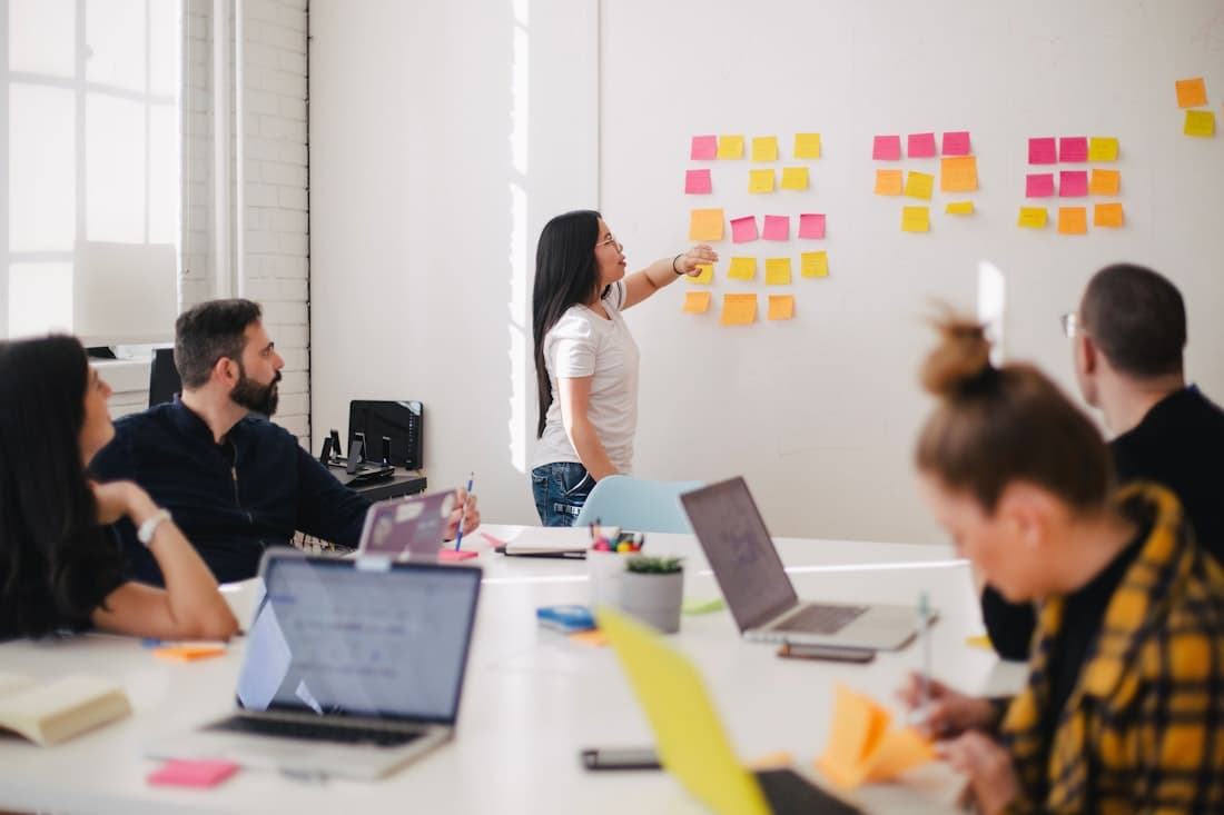 A team gathered around a work table in a bright office